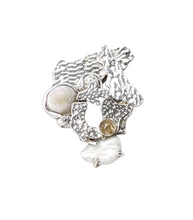 Load image into Gallery viewer,  This white coral brooch is about recreating a memory of a white beach. There are two parts of the brooch: one is a hand textured silver piece with a brooch pin and another is decorative silver corals with shells, a coral and a rutilated quartz. They are connected together with two jump rings behind the brooch allowing it make some movement.  Sterling silver, dead coral and shells from a beach in Okinawa, Japan Stone: rutilated quarts Approx. 40mm x 50mm x 15mm